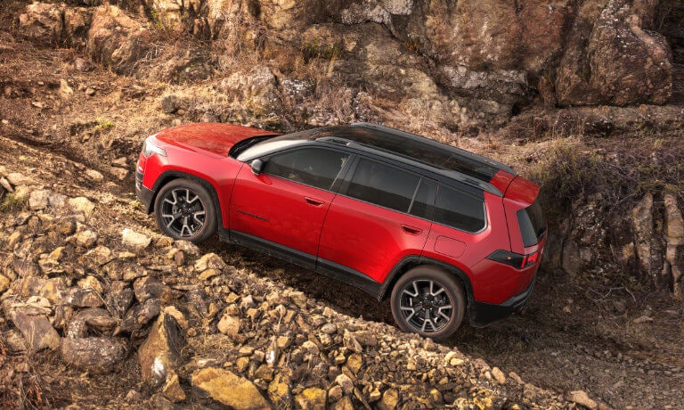 2026 Jeep Cherokee driving up rocky incline