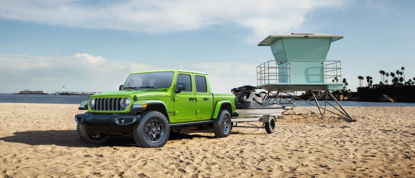 2026 Jeep Gladiator parked on beach with jetski
