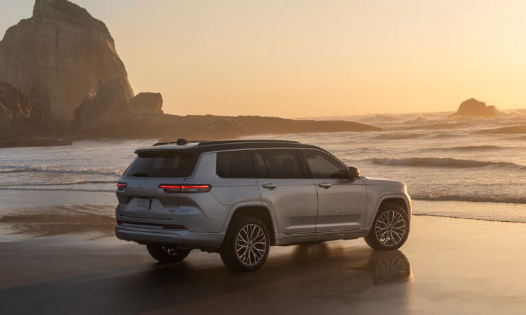2026 Jeep Grand Cherokee parked facing ocean rocks