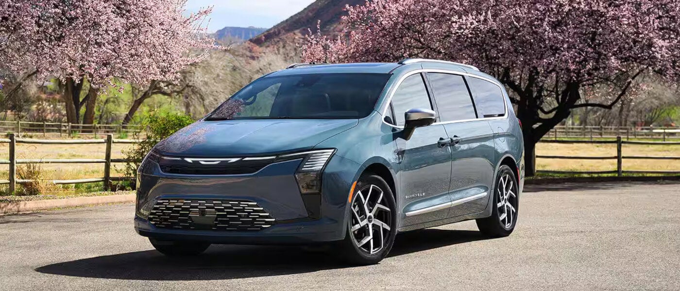 2027 Chrysler Pacifica parked by a cherry tree
